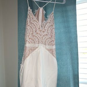 Fitted white dress. Goes to right above knees.